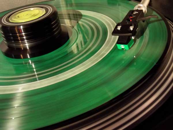 An image of a vinyl record playing on a turntable